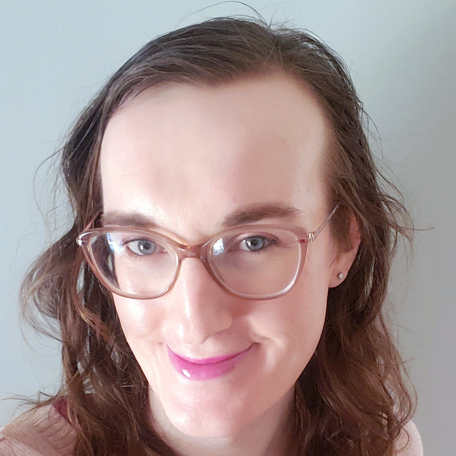 Headshot of me with long hair, pink lip stick, light makeup