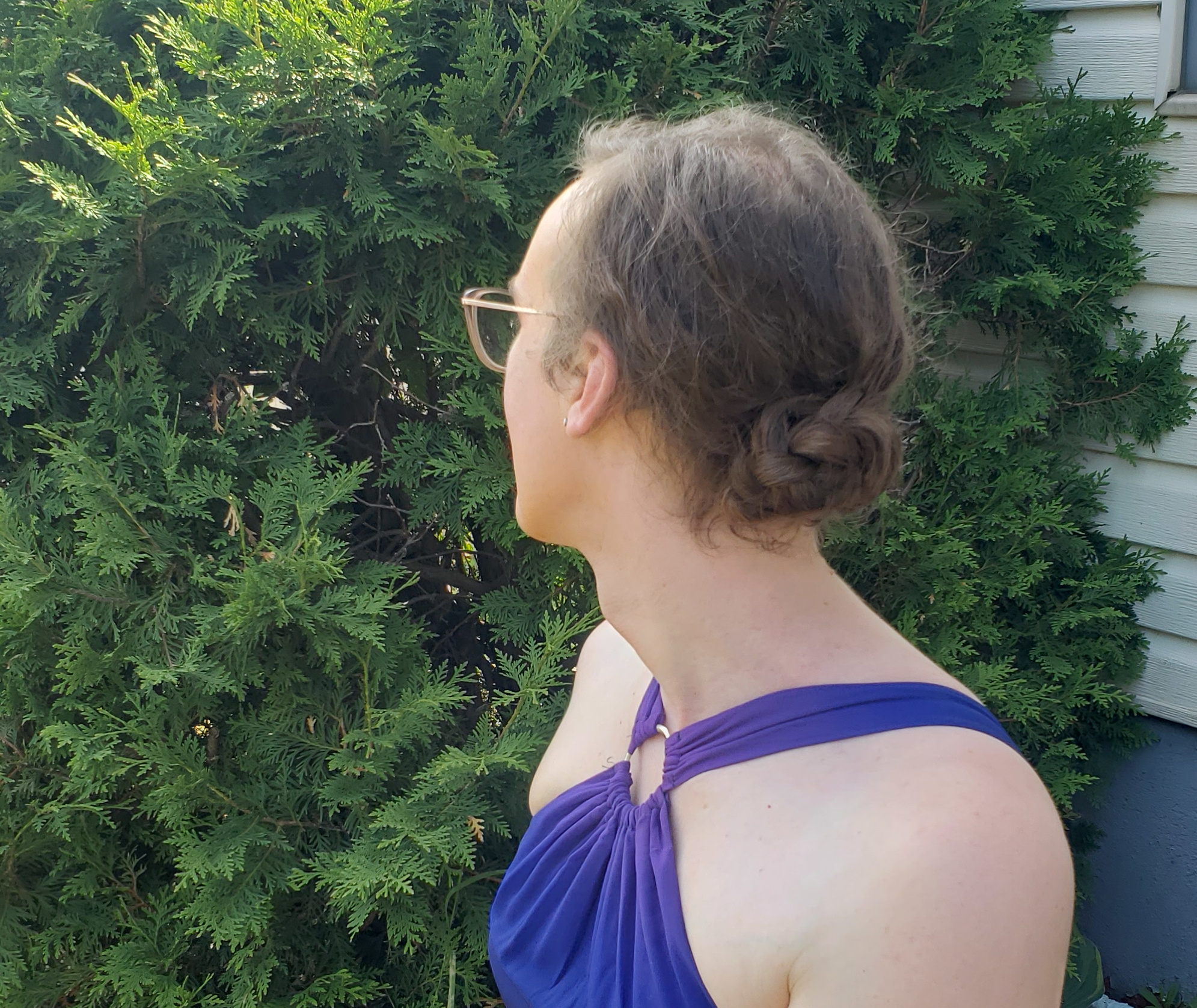The back of my head, showing a braided bun at the nape of my neck. I'm wearing the halterneck dress as described earlier in this post.